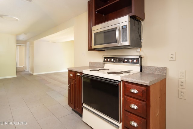 123 Manor Rd, Clinton, TN 37716 - kitchen featuring stainless steel microwave, white electric range, dark brown cabinets, light countertops, and baseboards