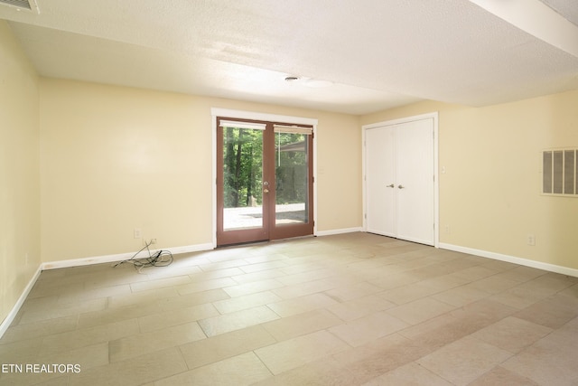 123 Manor Rd, Clinton, TN 37716 - empty room featuring baseboards, a textured ceiling, and french doors
