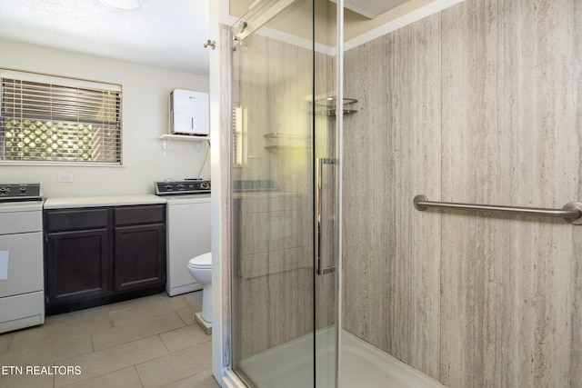 123 Manor Rd, Clinton, TN 37716 - full bathroom featuring washer / clothes dryer, tile patterned floors, and toilet