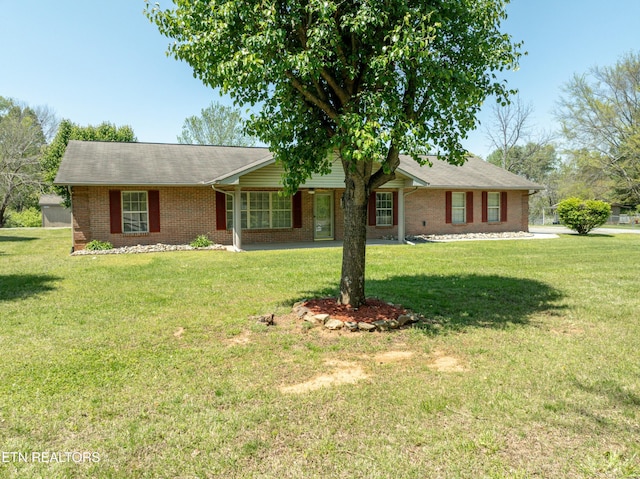 ranch-style house with brick siding and a front yard