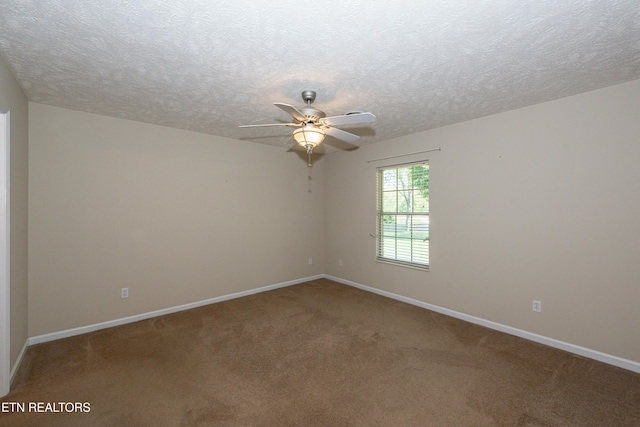 spare room with a ceiling fan, baseboards, carpet, and a textured ceiling