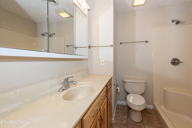 bathroom featuring a textured ceiling, vanity, toilet, and a shower