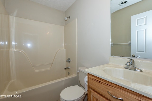 full bath featuring shower / washtub combination, visible vents, toilet, vanity, and a textured ceiling