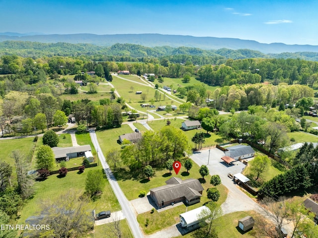 bird's eye view with a forest view and a mountain view