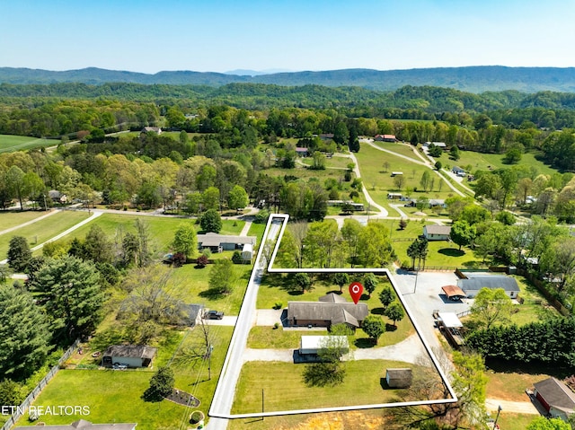 drone / aerial view with a forest view and a mountain view