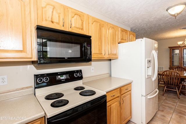 kitchen featuring electric range, white refrigerator with ice dispenser, black microwave, light countertops, and light tile patterned floors