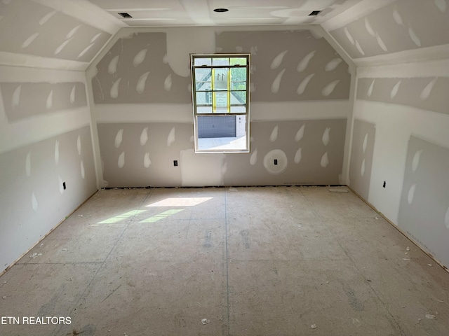 additional living space featuring visible vents and lofted ceiling
