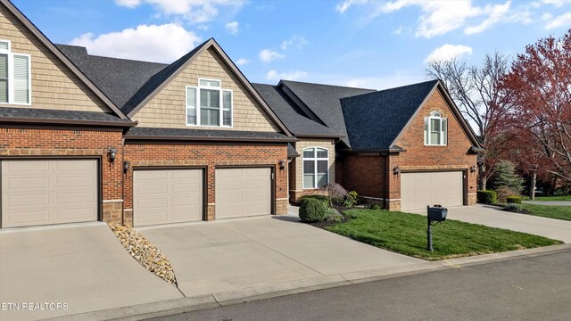 view of front facade featuring a garage, brick siding, and driveway