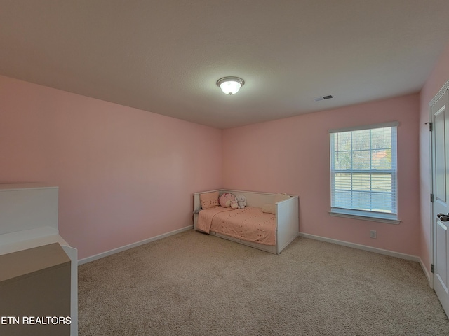 unfurnished bedroom featuring visible vents, baseboards, and carpet