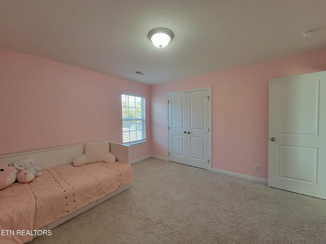unfurnished bedroom with visible vents, baseboards, carpet flooring, and a closet