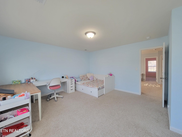bedroom with light carpet and baseboards