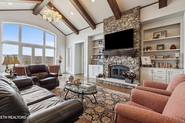 950 White Wing Rd, Lenoir City, TN 37771 - living room featuring high vaulted ceiling, wood finished floors, beam ceiling, a stone fireplace, and an inviting chandelier