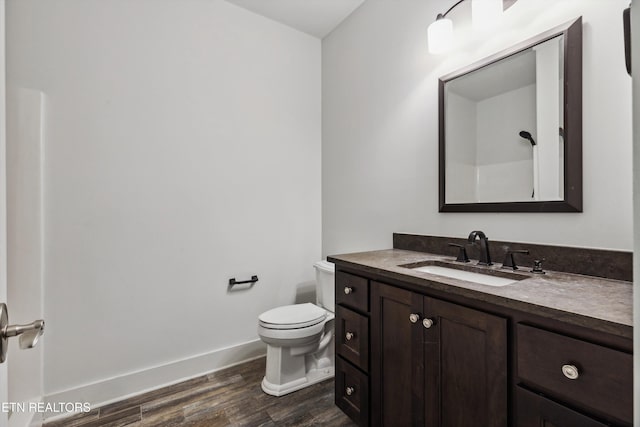 950 White Wing Rd, Lenoir City, TN 37771 - bathroom with baseboards, wood finished floors, toilet, and vanity