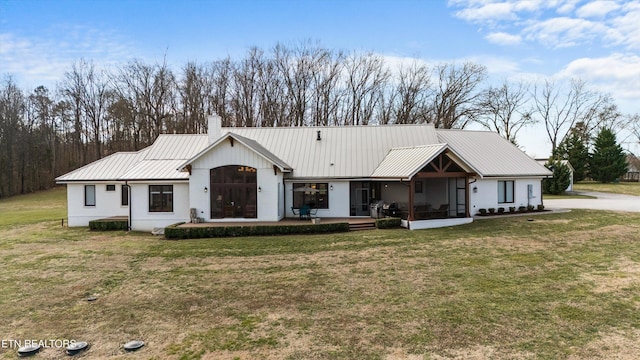 950 White Wing Rd, Lenoir City, TN 37771 - view of front of property featuring a front lawn, a chimney, a sunroom, and metal roof