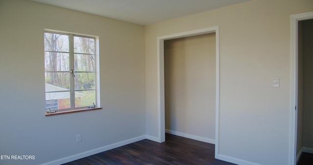 unfurnished bedroom with dark wood-style floors and baseboards