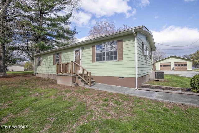 view of front of home with an outbuilding, a front yard, crawl space, and central AC unit