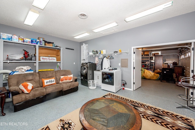living room with washer / dryer, visible vents, and speckled floor