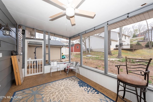 sunroom featuring a ceiling fan