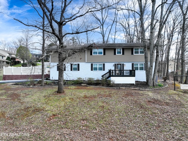 view of front of home featuring fence