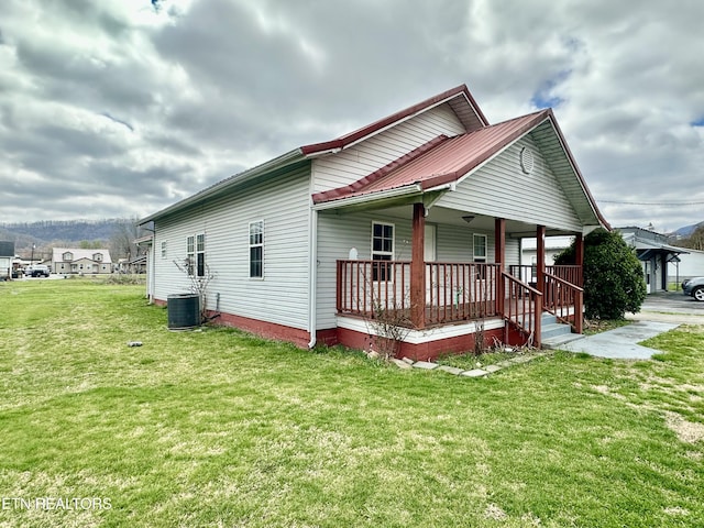 921 Winchester Ave, Middlesboro, KY 40965 - exterior space featuring a porch, central air condition unit, a lawn, and metal roof