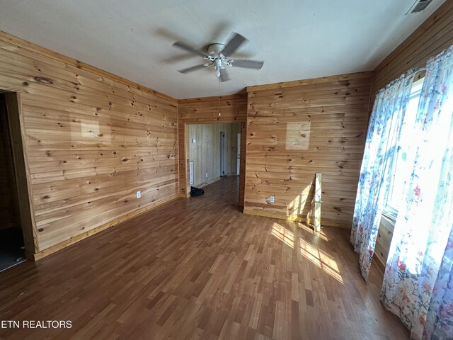 921 Winchester Ave, Middlesboro, KY 40965 - spare room featuring visible vents, wood walls, ceiling fan, and wood finished floors