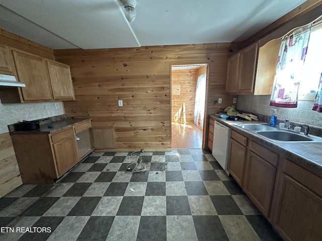 921 Winchester Ave, Middlesboro, KY 40965 - kitchen with a sink, under cabinet range hood, wood walls, dark floors, and white dishwasher