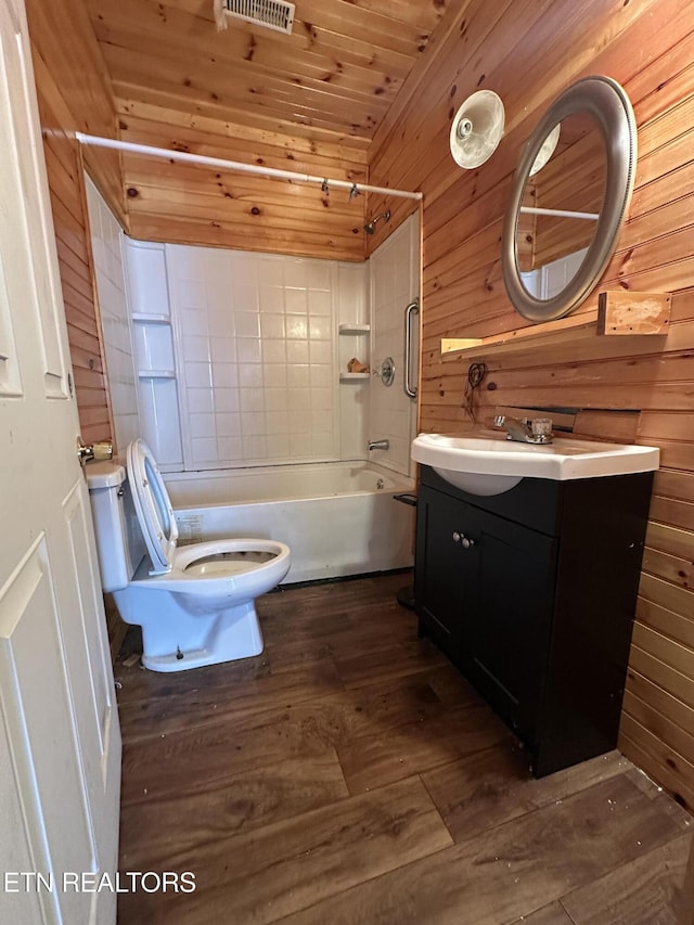 921 Winchester Ave, Middlesboro, KY 40965 - full bath with bathtub / shower combination, toilet, wood finished floors, and wood walls
