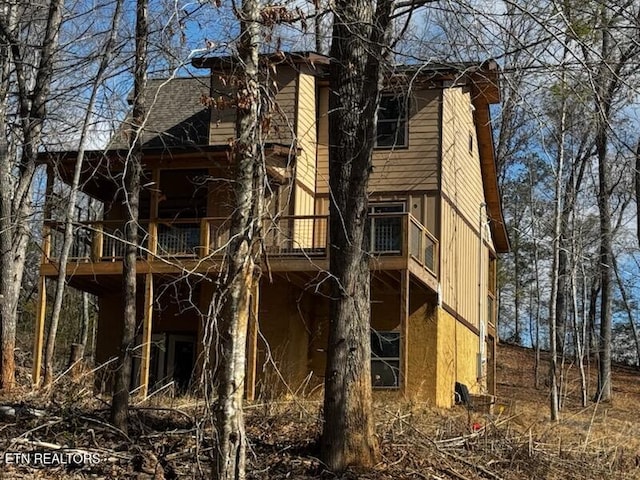 exterior space with roof with shingles