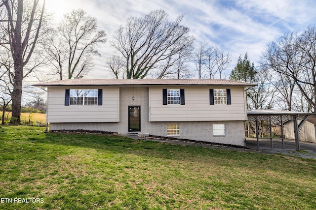 raised ranch with a carport and a front yard
