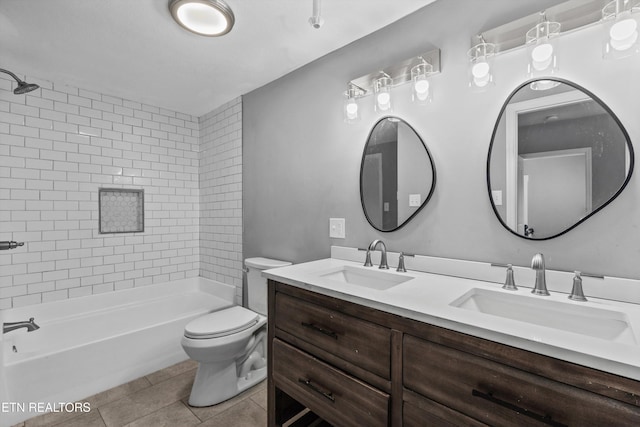 full bathroom with a sink, toilet, double vanity, and tile patterned floors