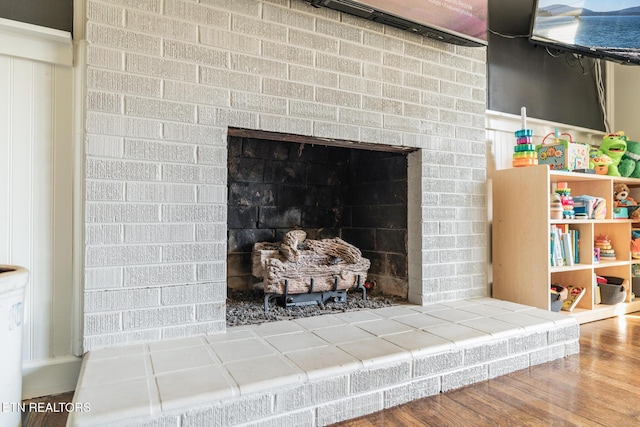 interior details featuring wood finished floors and a fireplace