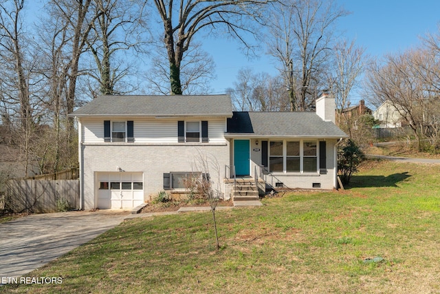 split level home with a front lawn, driveway, a garage, brick siding, and a chimney