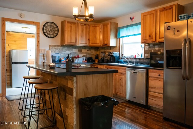 4662 Baker Hwy, Huntsville, TN 37756 - kitchen with dark countertops, backsplash, appliances with stainless steel finishes, and dark wood-style flooring