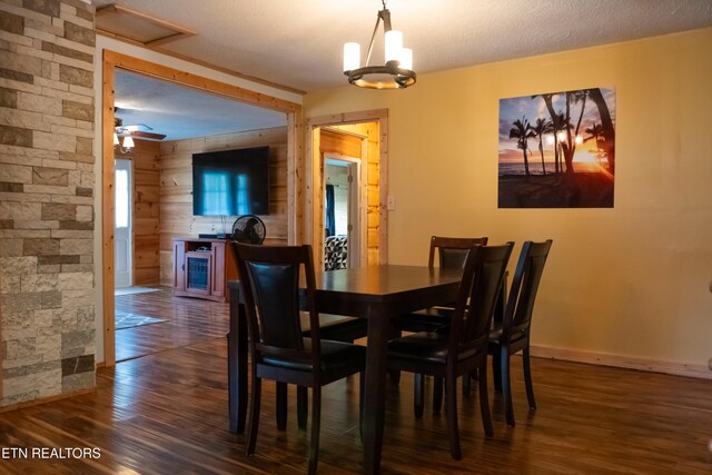 4662 Baker Hwy, Huntsville, TN 37756 - dining area featuring wooden walls, baseboards, dark wood-style flooring, wine cooler, and a textured ceiling