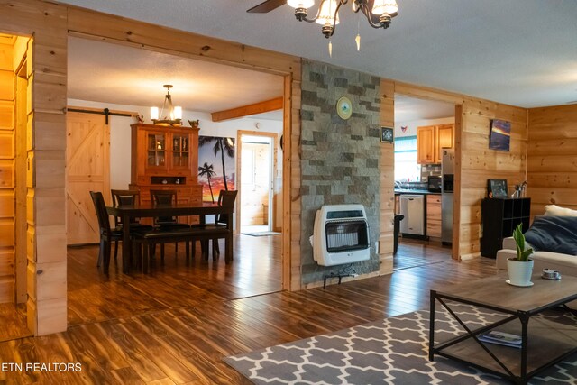 4662 Baker Hwy, Huntsville, TN 37756 - living room with hardwood / wood-style floors, a barn door, heating unit, and an inviting chandelier