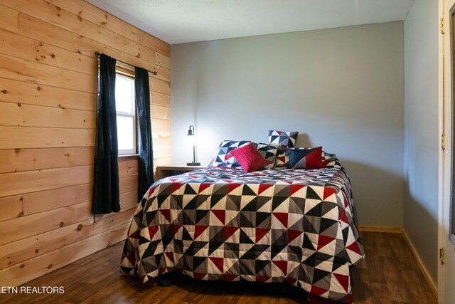 4662 Baker Hwy, Huntsville, TN 37756 - bedroom with baseboards, dark wood-style flooring, and wood walls