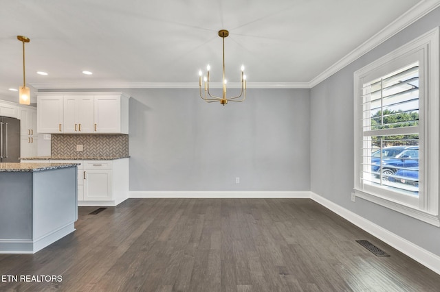 kitchen featuring visible vents, ornamental molding, light stone counters, decorative backsplash, and an inviting chandelier