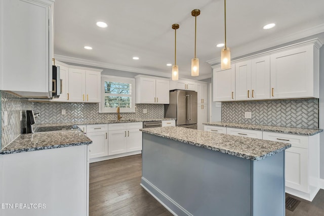 kitchen featuring dark wood-style floors, light stone countertops, stainless steel appliances, white cabinets, and crown molding