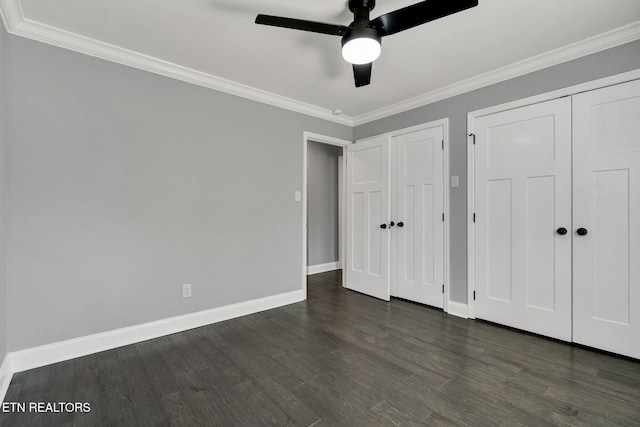 unfurnished bedroom with dark wood-style floors, ceiling fan, crown molding, and baseboards