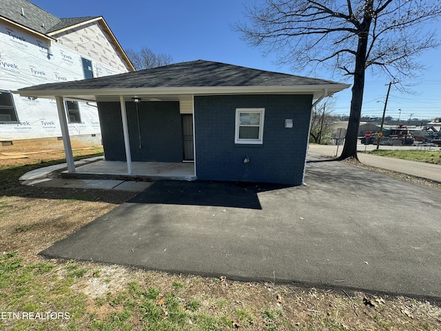 rear view of property featuring brick siding
