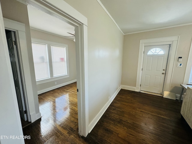 foyer entrance featuring dark wood-style floors, a ceiling fan, baseboards, and ornamental molding