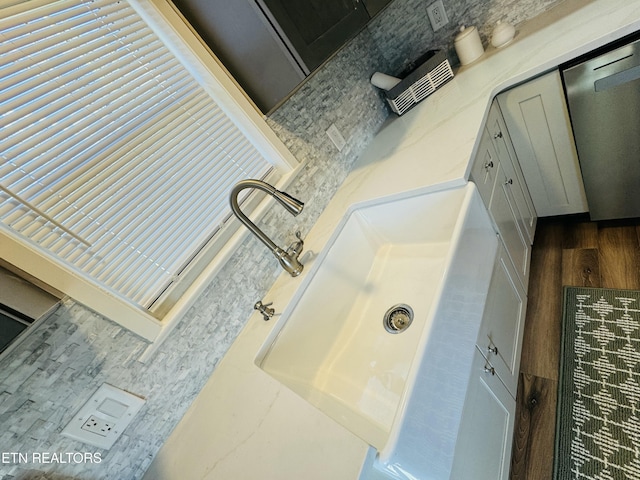 bathroom with a sink and wood finished floors