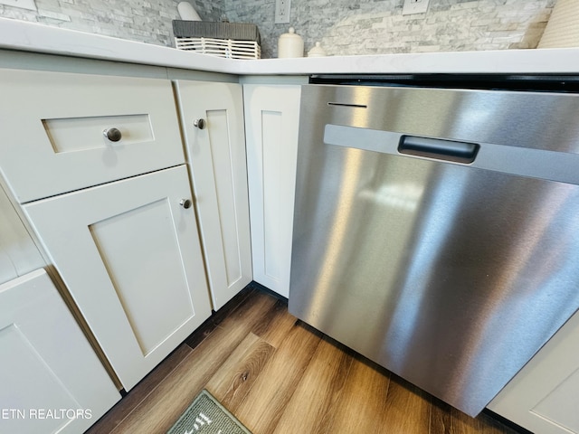 details with dishwasher, dark wood finished floors, and white cabinets