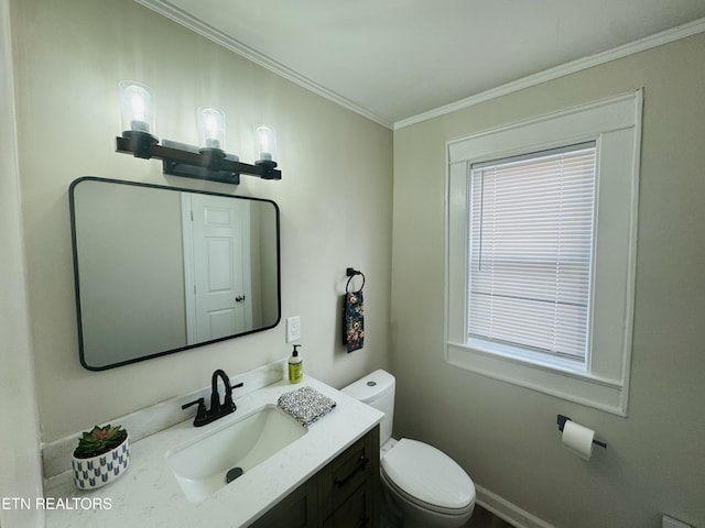bathroom featuring vanity, crown molding, and toilet