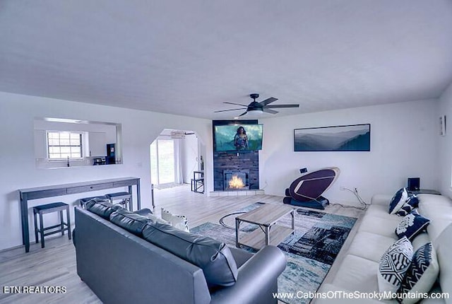2218 Red Bank Cir, Sevierville, TN 37862 - living area featuring a stone fireplace, plenty of natural light, ceiling fan, and wood finished floors