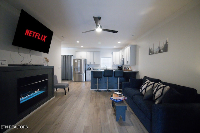 418 Fleeta Williams Way, Sevierville, TN 37862 - living area featuring light wood-type flooring, ceiling fan, a glass covered fireplace, and recessed lighting