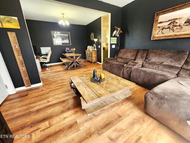 21876 E Coast Tellico Pkwy, Greenback, TN 37742 - living area featuring baseboards, an inviting chandelier, and wood finished floors