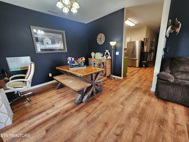 21876 E Coast Tellico Pkwy, Greenback, TN 37742 - dining room featuring baseboards, visible vents, a chandelier, and light wood-type flooring