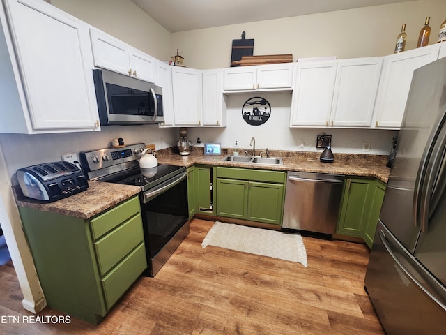 21876 E Coast Tellico Pkwy, Greenback, TN 37742 - kitchen featuring white cabinetry, a sink, stainless steel appliances, green cabinets, and light wood-type flooring