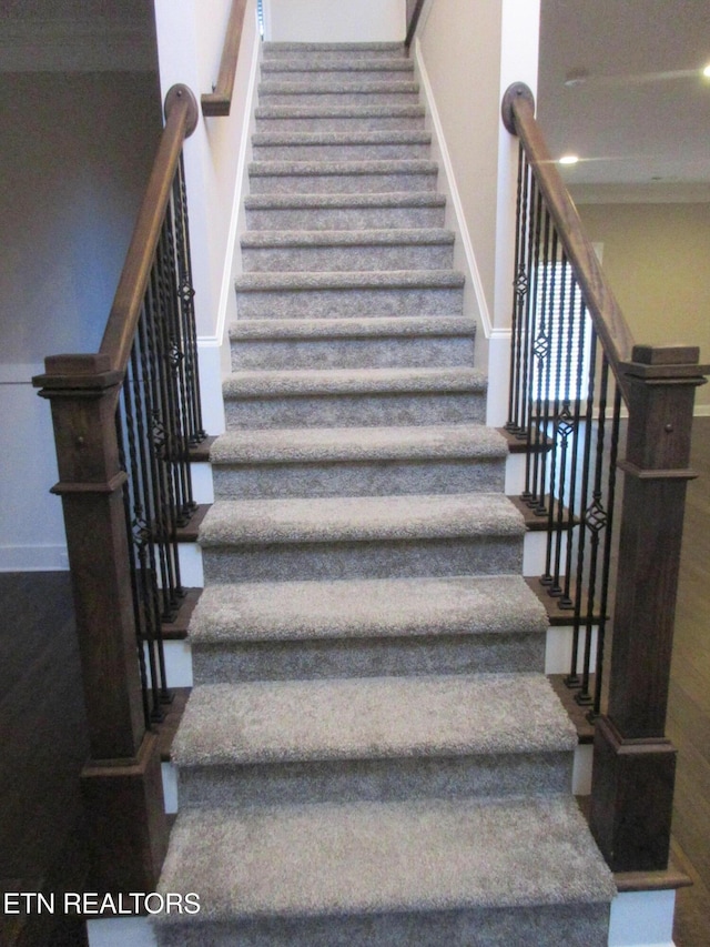 staircase featuring baseboards